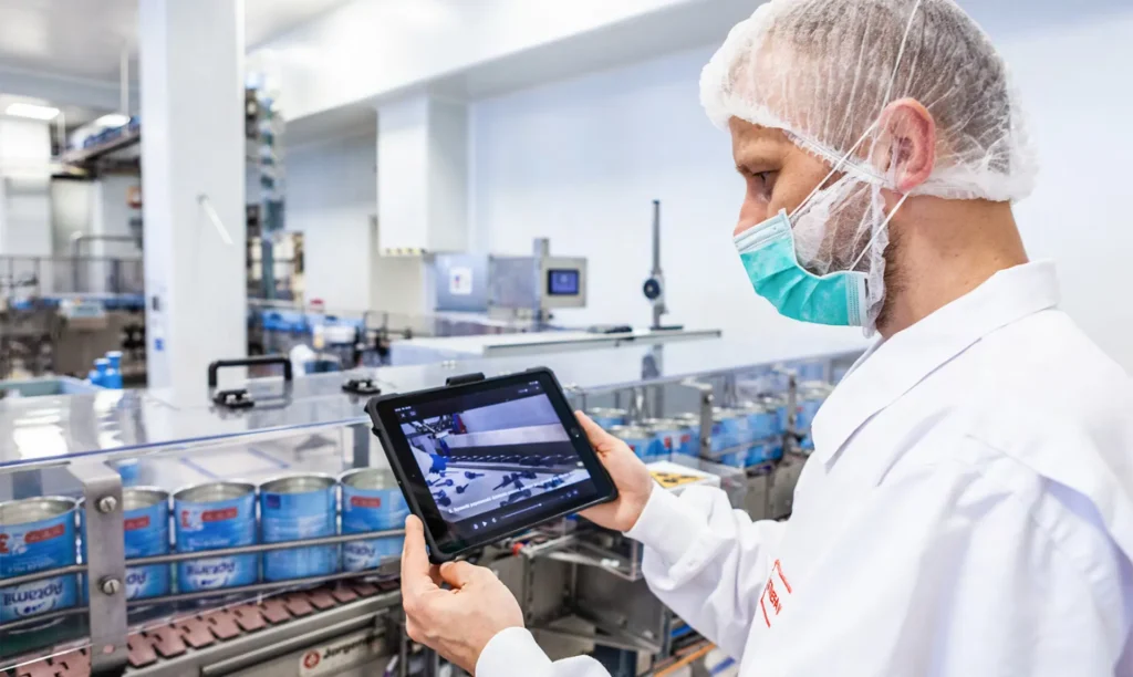 A man wearing a white lab coat is interacting with a tablet, likely conducting research or analysis.
