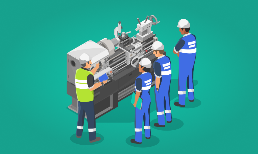 A diverse group of individuals collaborating on a complex machine in a workshop setting.