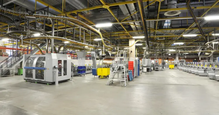 A factory interior filled with various machines and equipment, showcasing an industrial workspace.