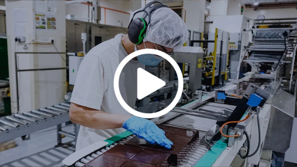 A factory worker carefully inspects an equipment.