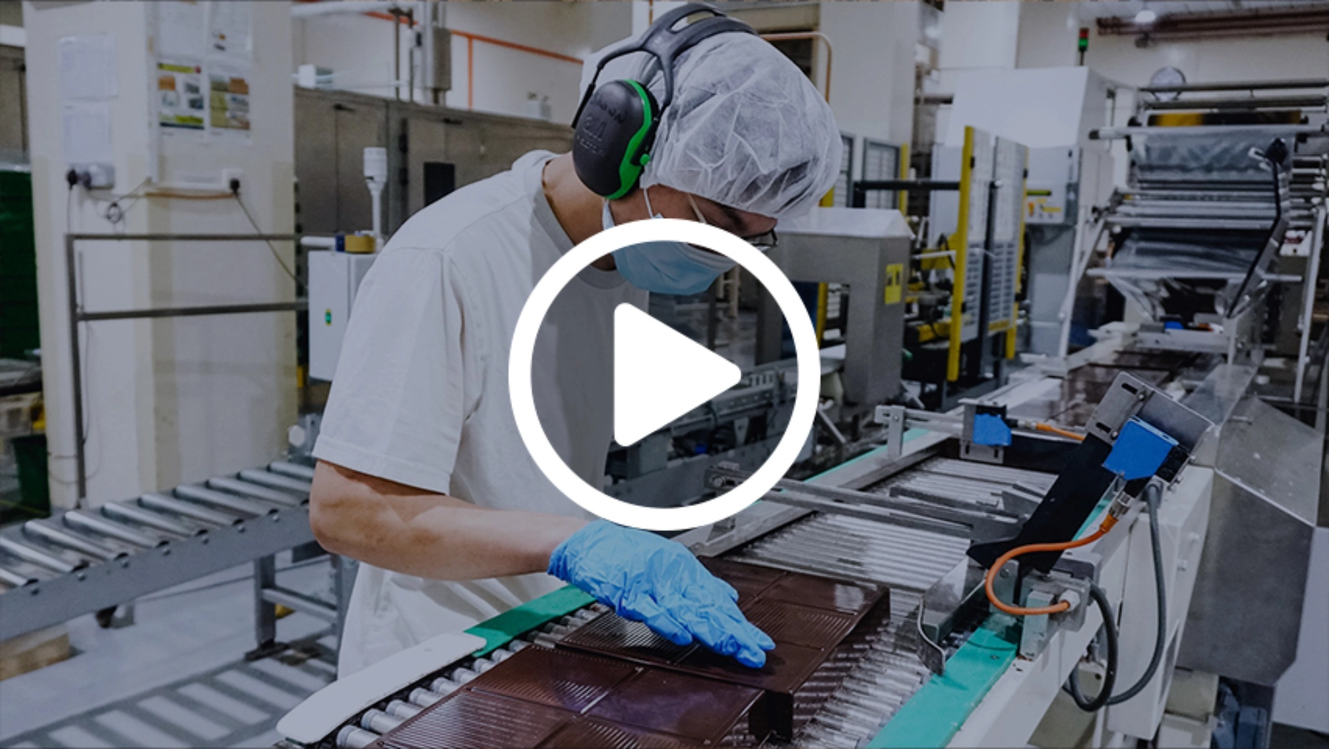 A factory worker carefully inspects an equipment.