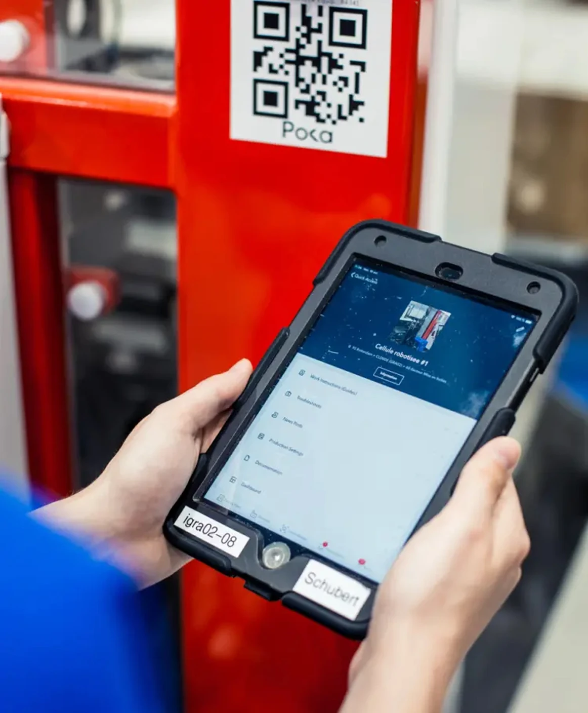 A person standing in front of a barcode holding an iPad viewing Poka App